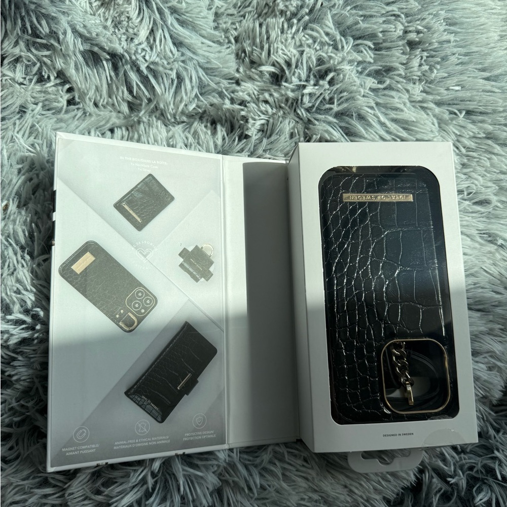 Elegant Black Crocodile Pattern iPhone 14 proCase with Ring Holder and a Sling.